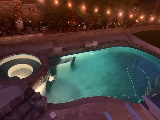 outdoor pool featuring an indoor in ground hot tub
