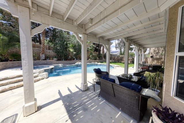 view of patio / terrace featuring a pool with connected hot tub and a fenced backyard