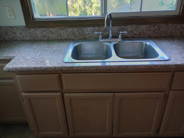 details featuring light countertops and a sink