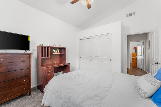 carpeted bedroom with lofted ceiling, visible vents, a closet, and ceiling fan