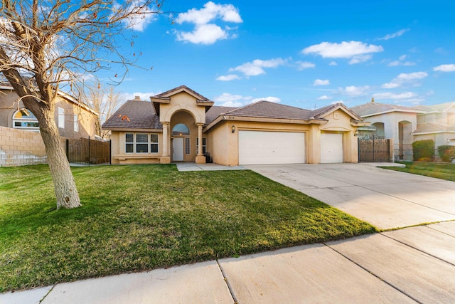 view of front of house with a front lawn, an attached garage, fence, and stucco siding