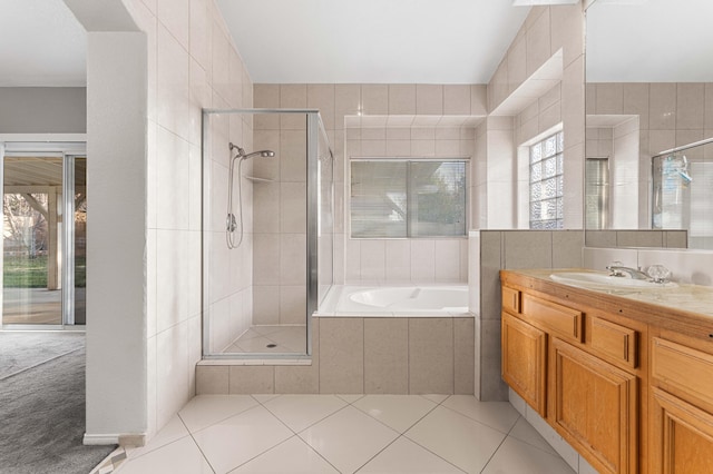 bathroom with vanity, a bath, a stall shower, and tile patterned flooring