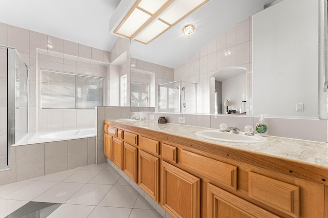 bathroom with lofted ceiling, a stall shower, a sink, tile patterned floors, and a bath