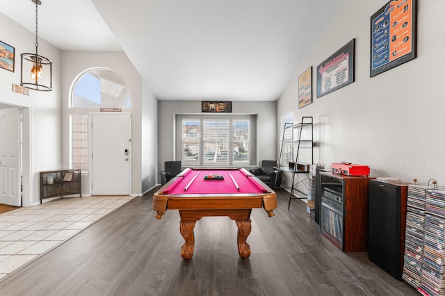 game room featuring baseboards, high vaulted ceiling, wood finished floors, and billiards