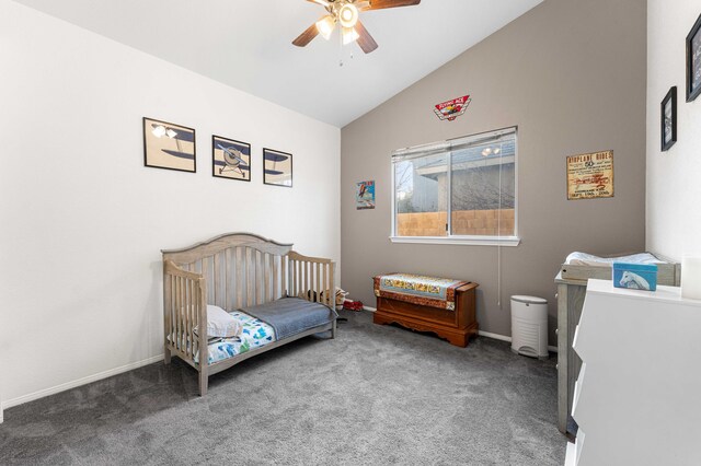 carpeted bedroom featuring baseboards, a nursery area, ceiling fan, and vaulted ceiling