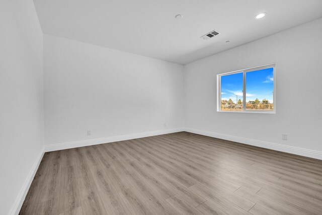 2929 W 28th St, Rosamond, CA 93560 - empty room featuring wood finished floors, baseboards, and recessed lighting