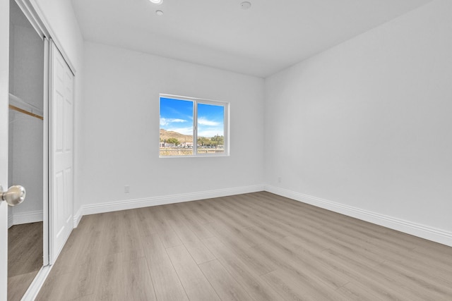 2929 W 28th St, Rosamond, CA 93560 - unfurnished bedroom featuring light wood-type flooring, a closet, and baseboards