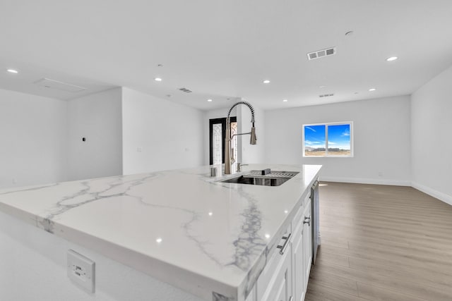 2929 W 28th St, Rosamond, CA 93560 - kitchen with open floor plan, a sink, light wood finished floors, recessed lighting, and an island with sink