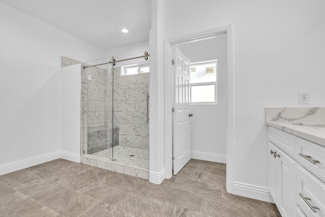2929 W 28th St, Rosamond, CA 93560 - bathroom featuring a marble finish shower, healthy amount of natural light, vanity, baseboards, and recessed lighting