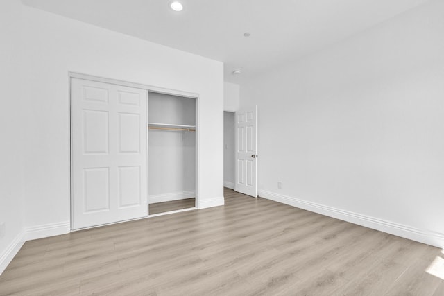 2929 W 28th St, Rosamond, CA 93560 - unfurnished bedroom with light wood-style floors, baseboards, a closet, and recessed lighting