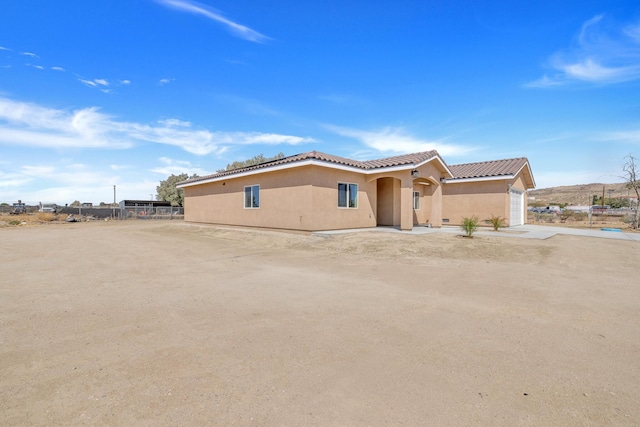 2929 W 28th St, Rosamond, CA 93560 - view of front of house featuring stucco siding, a tiled roof, and an attached garage