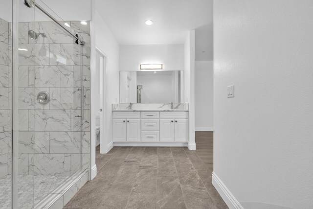 2929 W 28th St, Rosamond, CA 93560 - full bath with a marble finish shower, double vanity, toilet, baseboards, and recessed lighting