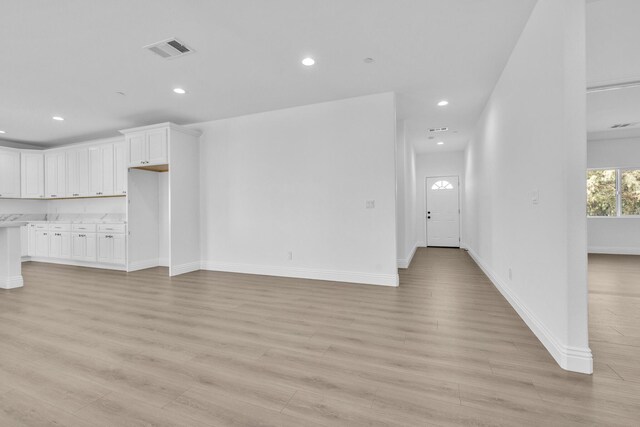 2929 W 28th St, Rosamond, CA 93560 - unfurnished living room with recessed lighting, light wood-type flooring, and baseboards
