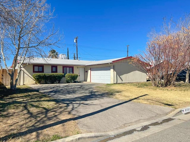 ranch-style house with driveway and a garage