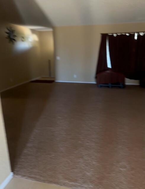 16466 Wells Fargo Ave, Palmdale, CA 93591 - unfurnished living room with baseboards and carpet flooring