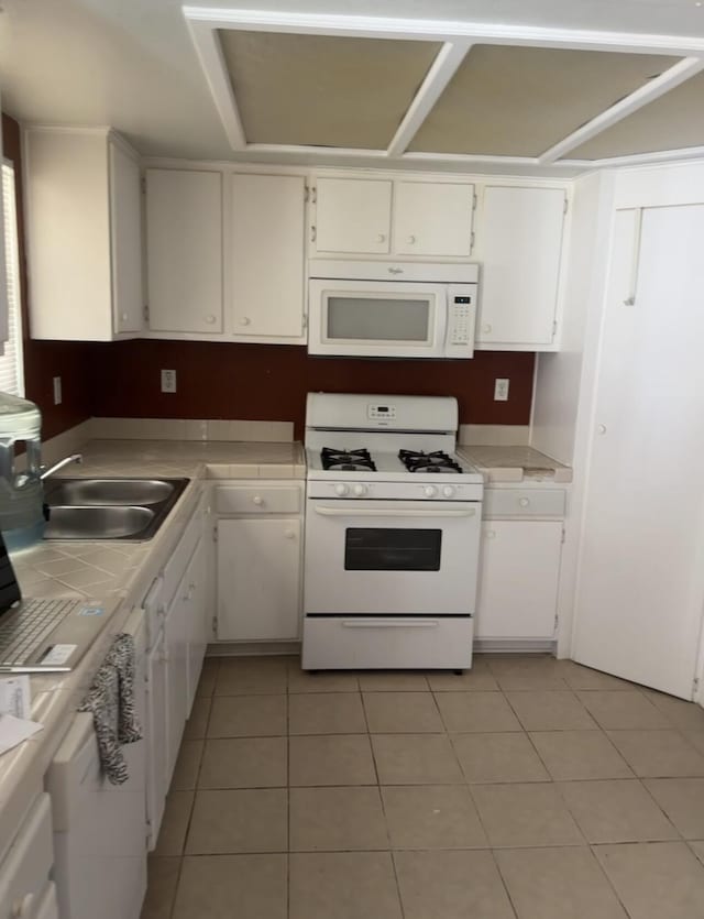 16466 Wells Fargo Ave, Palmdale, CA 93591 - kitchen featuring white appliances, tile countertops, white cabinets, a sink, and light tile patterned flooring