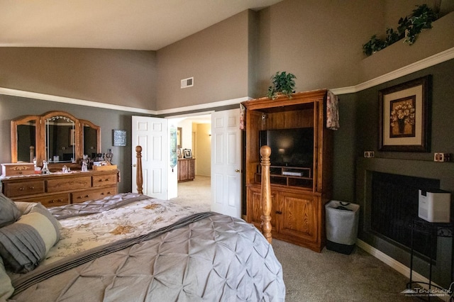 bedroom featuring vaulted ceiling, visible vents, and light colored carpet