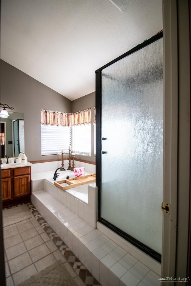 full bath with tile patterned flooring, vanity, vaulted ceiling, a shower stall, and a bath