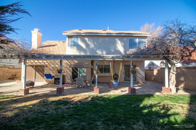 back of property featuring a yard, a patio area, fence, and a pergola