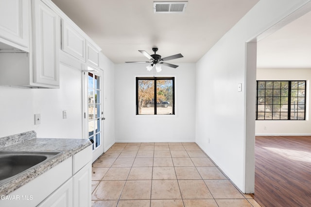 43331 Fairglen Rd, Lancaster, CA 93535 - kitchen featuring a ceiling fan, plenty of natural light, white cabinetry, and light tile patterned floors