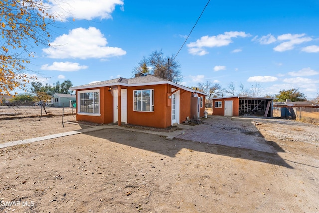 43331 Fairglen Rd, Lancaster, CA 93535 - view of front of home featuring an outdoor structure and stucco siding