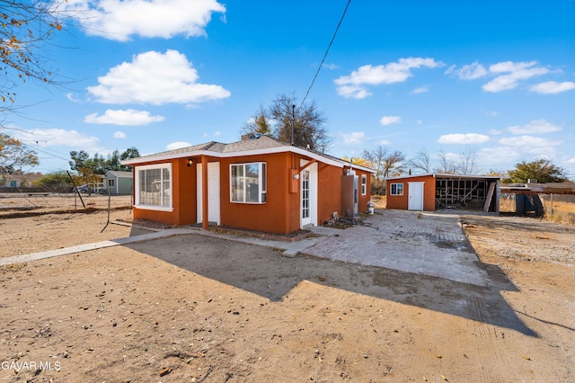 43331 Fairglen Rd, Lancaster, CA 93535 - view of front of house with stucco siding and an outbuilding