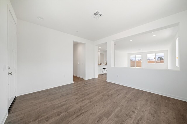 unfurnished room featuring recessed lighting, baseboards, visible vents, and wood finished floors