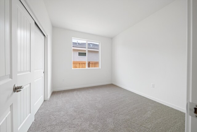 unfurnished bedroom with a closet, carpet flooring, and baseboards