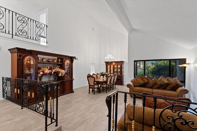 42722 W 20th St, Lancaster, CA 93534 - living room with high vaulted ceiling, a textured ceiling, wood finished floors, and a chandelier