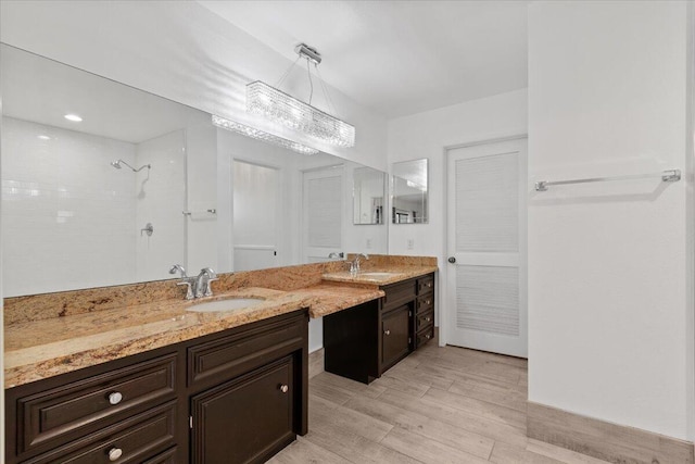 42722 W 20th St, Lancaster, CA 93534 - bathroom featuring a tile shower, wood finished floors, and vanity
