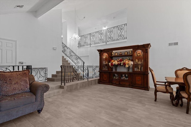 42722 W 20th St, Lancaster, CA 93534 - living room with high vaulted ceiling, a chandelier, stairway, and wood finished floors