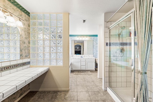 bathroom featuring a shower stall, vanity, baseboards, and tile patterned floors