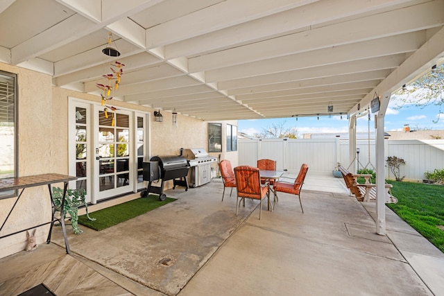 view of patio / terrace featuring outdoor dining area, grilling area, and fence