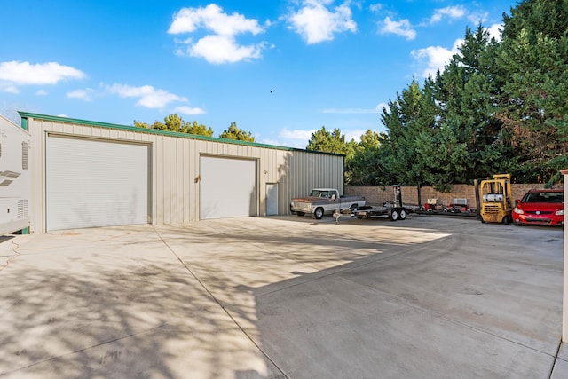 detached garage featuring fence