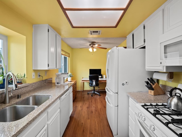 kitchen featuring visible vents, a sink, dark wood-style floors, white appliances, and white cabinets