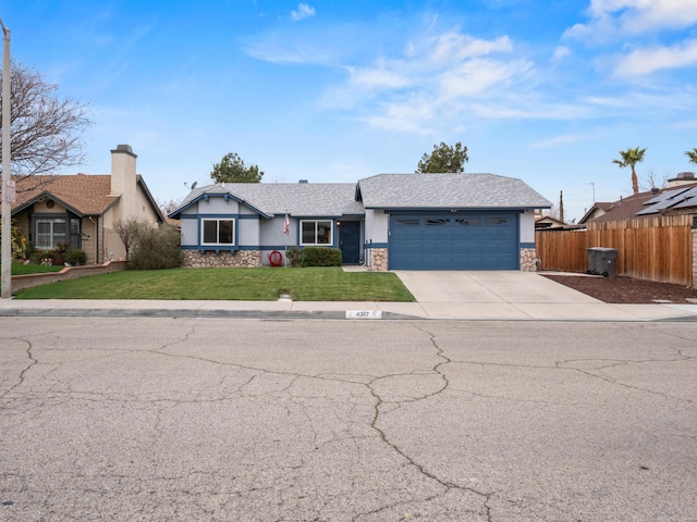 ranch-style home with stucco siding, a front lawn, stone siding, fence, and an attached garage