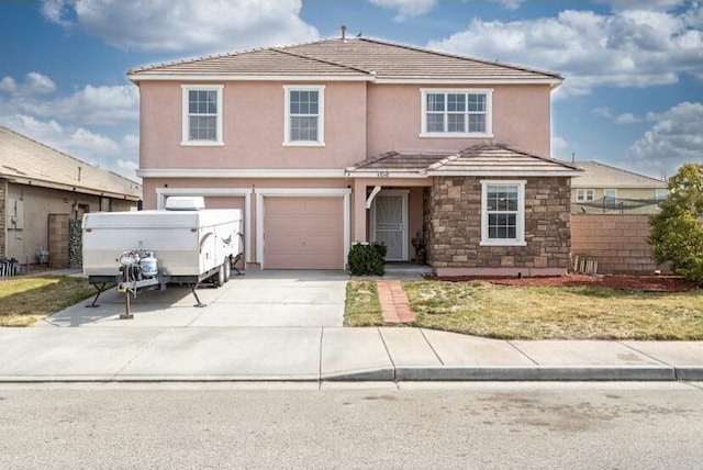 view of property with a garage and a front lawn