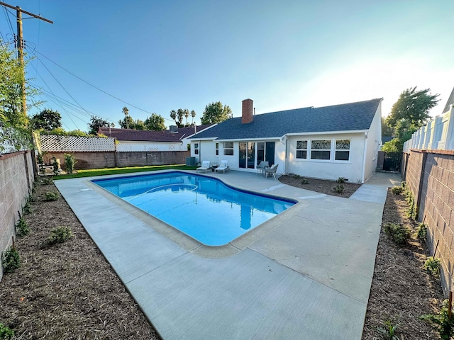 view of swimming pool featuring a patio, a fenced backyard, and a fenced in pool