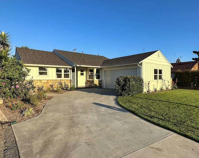 single story home with concrete driveway, stone siding, an attached garage, a front lawn, and board and batten siding