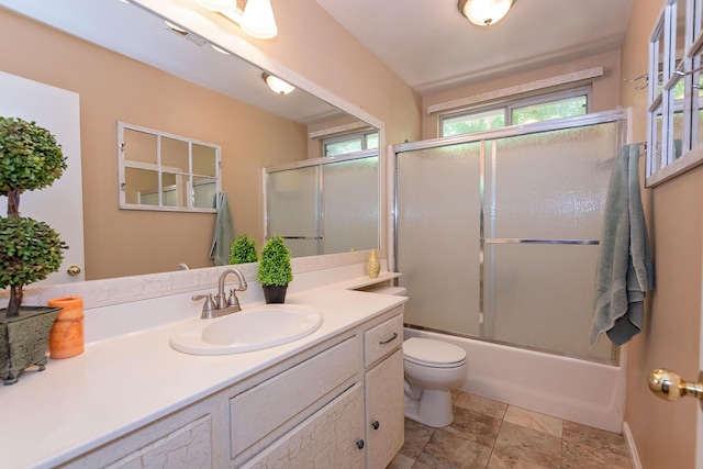 6310 Treehaven Ct, Lancaster, CA 93536 - bathroom featuring vanity, bath / shower combo with glass door, and stone finish floors