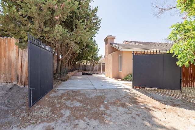 6310 Treehaven Ct, Lancaster, CA 93536 - view of property exterior featuring a chimney, stucco siding, and a patio area