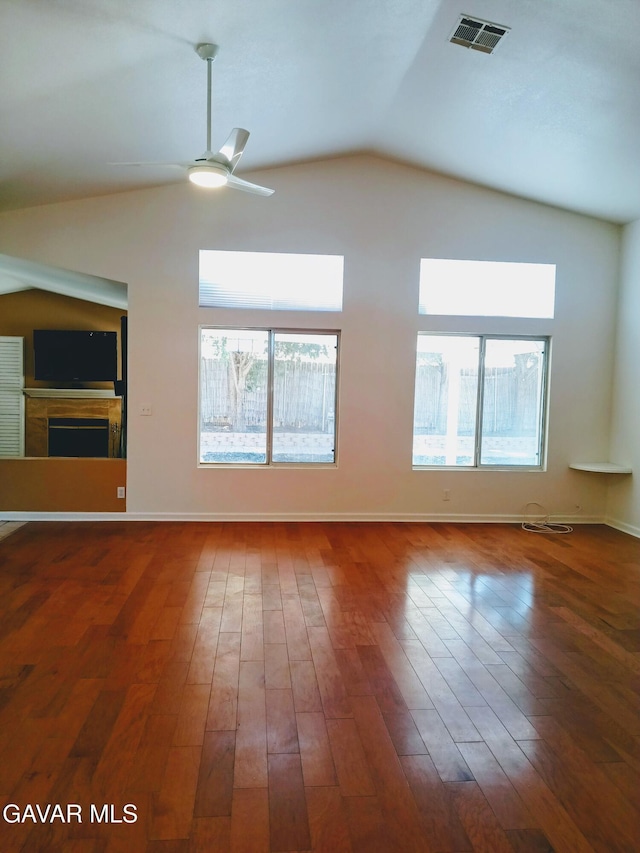 6310 Treehaven Ct, Lancaster, CA 93536 - unfurnished living room with vaulted ceiling, ceiling fan, wood-type flooring, plenty of natural light, and a fireplace