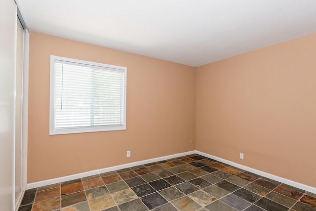 6310 Treehaven Ct, Lancaster, CA 93536 - spare room with dark stone finish floors and baseboards