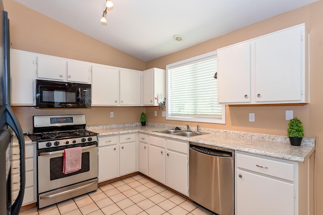 6310 Treehaven Ct, Lancaster, CA 93536 - kitchen with stainless steel appliances, lofted ceiling, light countertops, white cabinetry, and light tile patterned flooring