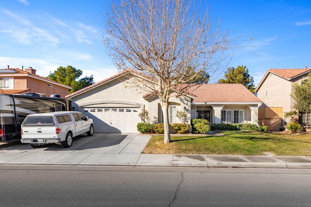 view of front of house with a garage and a front lawn