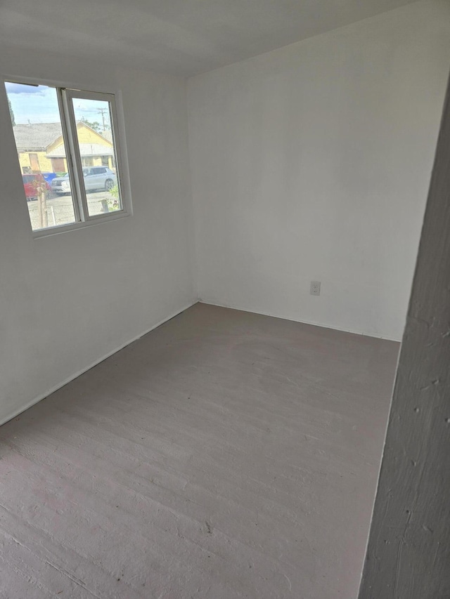 spare room with wood finished floors