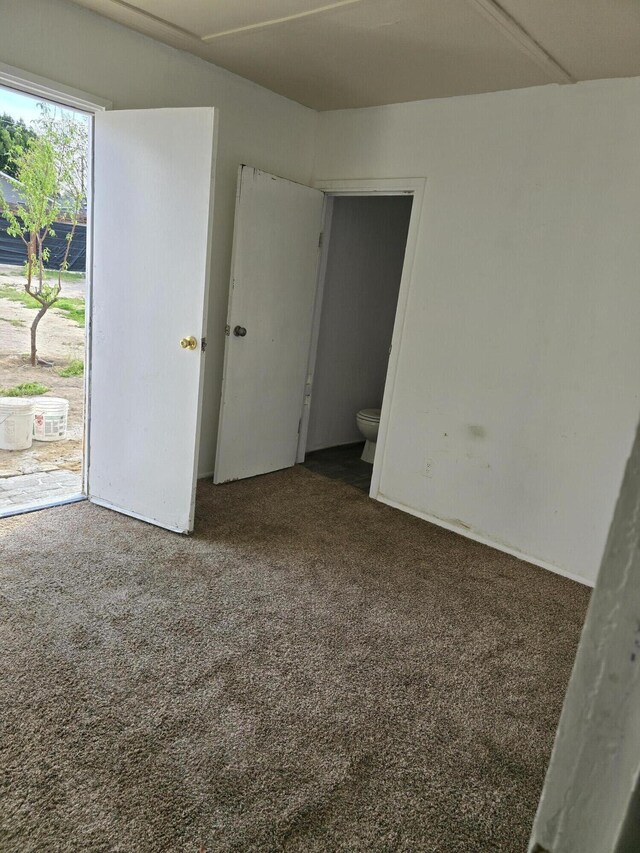 127 N St, Taft, CA 93268 - unfurnished bedroom featuring carpet floors and access to outside