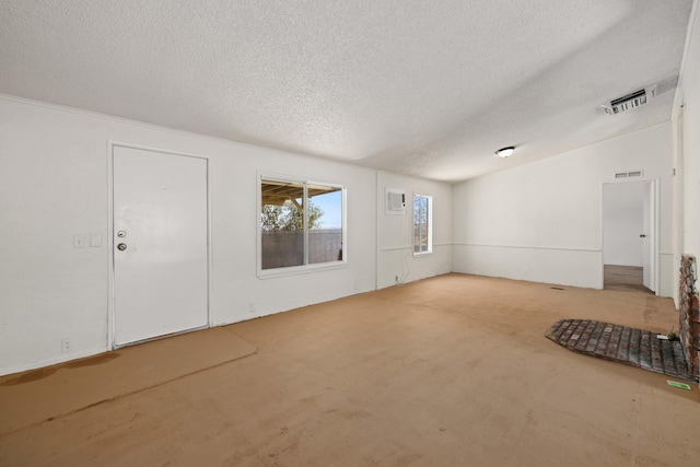 23610 Lancaster Rd, Lancaster, CA 93536 - unfurnished living room featuring a textured ceiling, visible vents, and unfinished concrete flooring