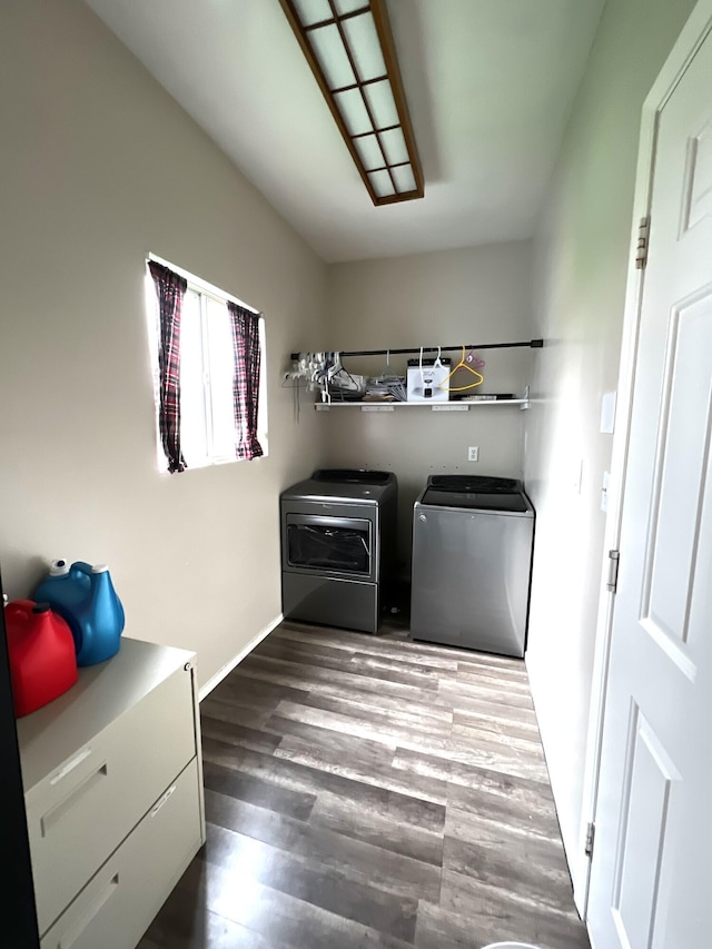 clothes washing area with washer and clothes dryer and dark hardwood / wood-style floors