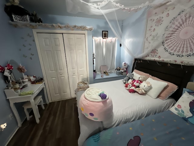 bedroom with a closet and dark wood-type flooring